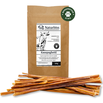 Verpackung von Naturbiss Hundespaghetti vor einem Haufen der Leckerlis. Monoprotein Rind aus 100% Rinderdärmen.